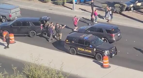 Students are led out of UNLV with their hands above their heads Wednesday afternoon