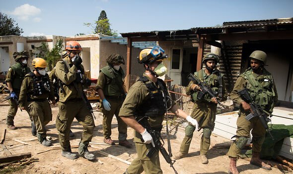 Israeli soldiers at the site of a massacre in Kfar Aza