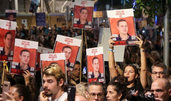Pictures of hostages held aloft during the Tel Aviv protest