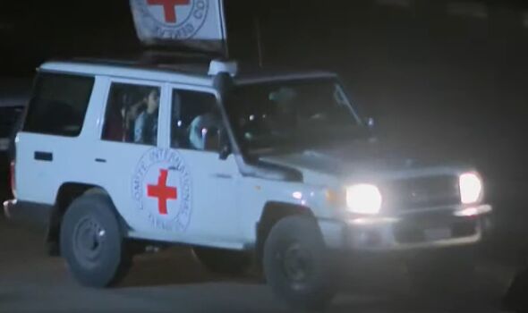 Hostages being taken to safety in a Red Cross vehicle
