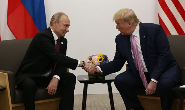 Donald Trump shakes hand with Putin
